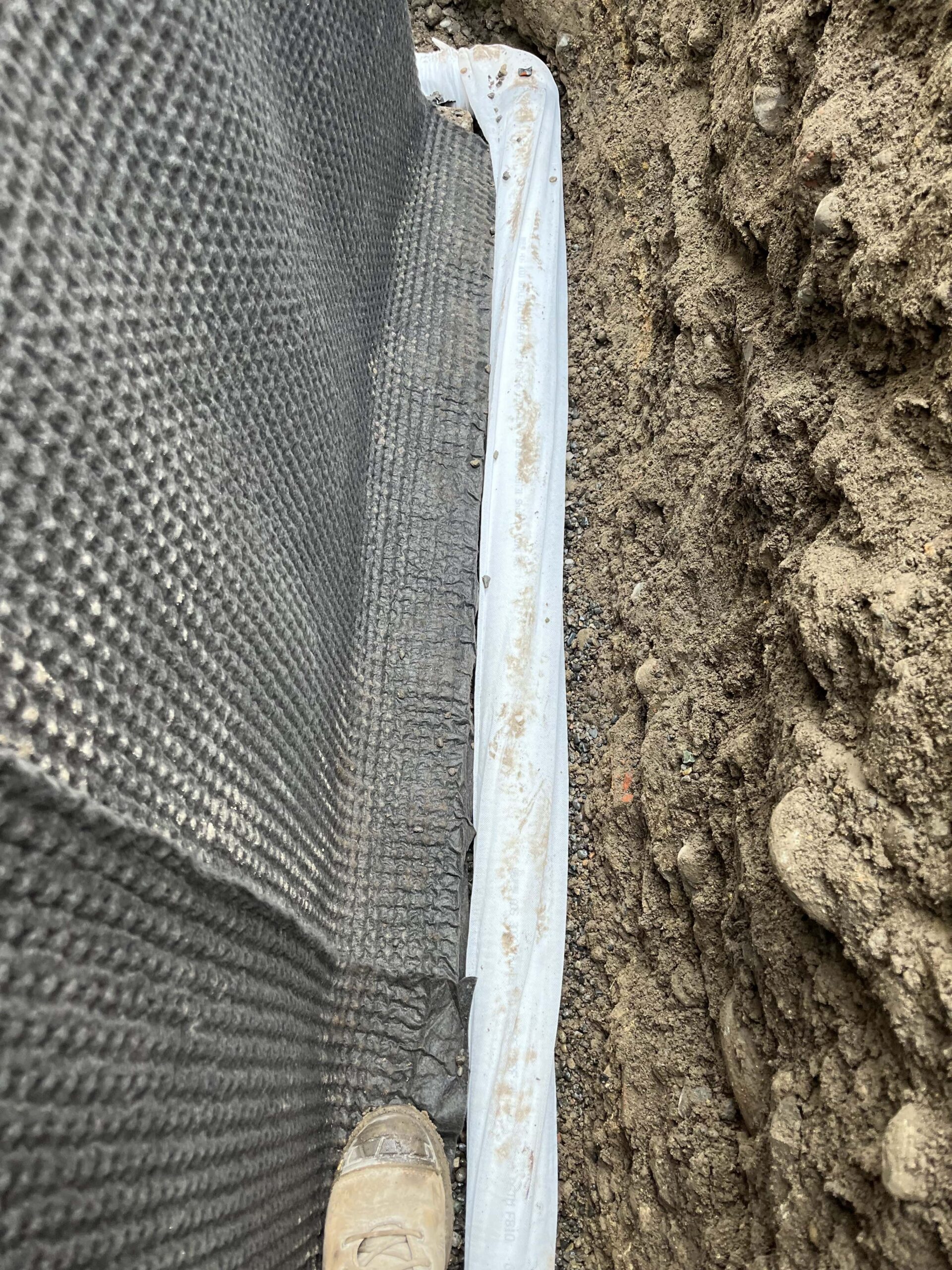 installation of a french drain pipe for a basement waterproofing project in Everett, WA