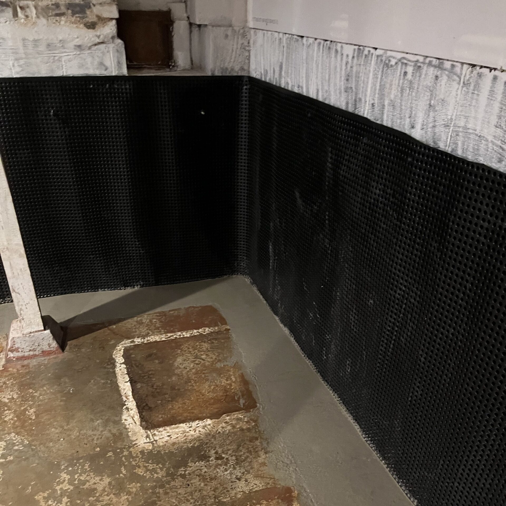 Interior basement waterproofing system installed look