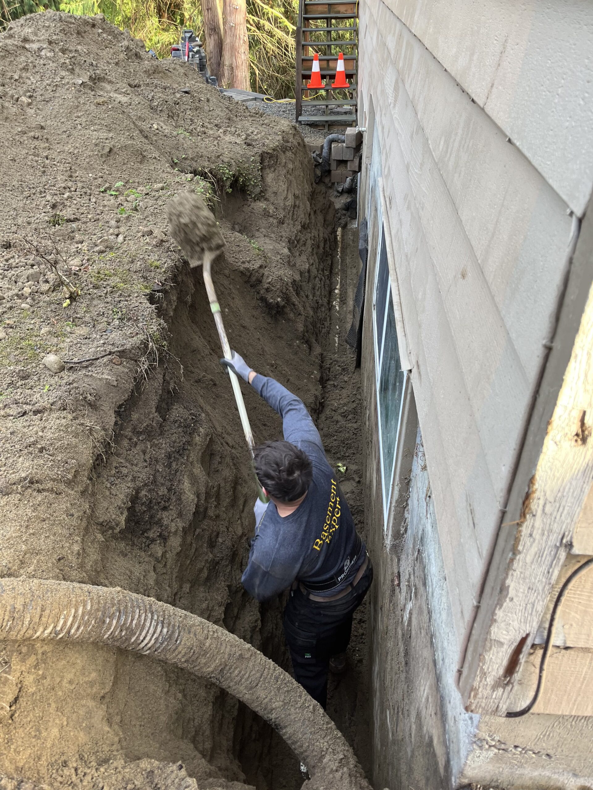 Ivan is digging out a trench to reach out to foundation footing in order to install a basement waterproofing system
