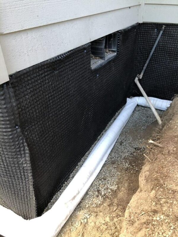first stage of french drain installation for exterior basement waterproofing system